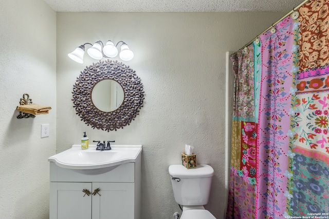 bathroom featuring walk in shower, toilet, a textured ceiling, and vanity