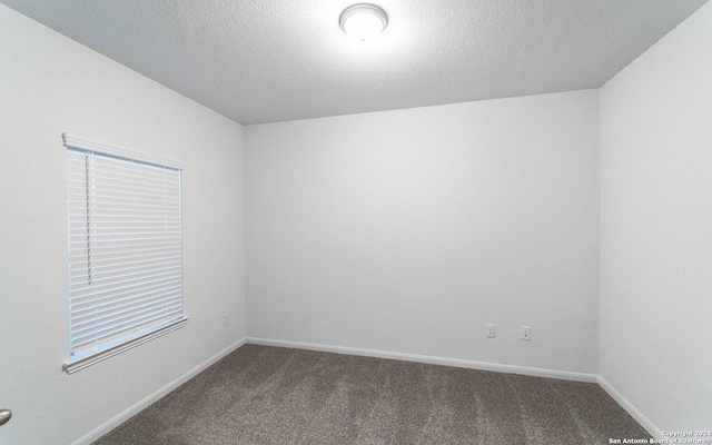 413 Tims Way, Seguin, TX 78155 - unfurnished room featuring dark colored carpet, baseboards, and a textured ceiling