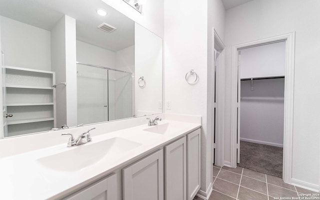 413 Tims Way, Seguin, TX 78155 - full bathroom with a spacious closet, a stall shower, double vanity, tile patterned floors, and baseboards