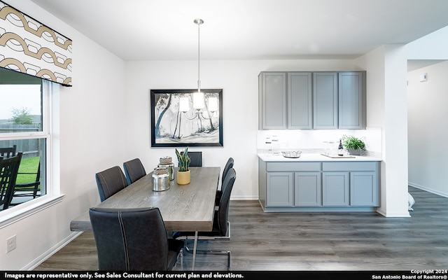 dining space featuring hardwood / wood-style flooring and a chandelier