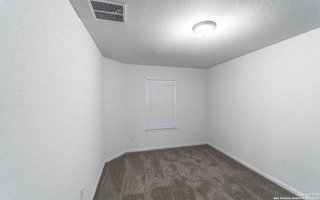 413 Tims Way, Seguin, TX 78155 - unfurnished room with dark carpet, a textured ceiling, and baseboards