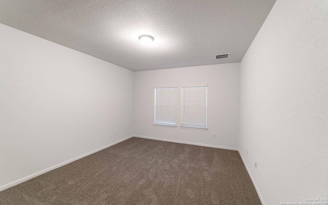 413 Tims Way, Seguin, TX 78155 - unfurnished room featuring dark carpet, a textured ceiling, and baseboards