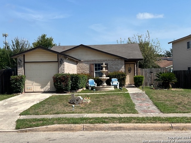 ranch-style house featuring a garage and a front lawn