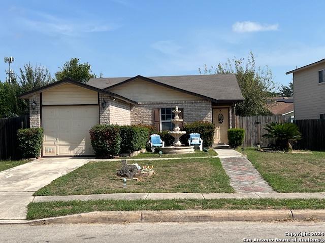 10131 Southern Sun, San Antonio, TX 78245 - ranch-style home featuring concrete driveway, a front yard, fence, and an attached garage