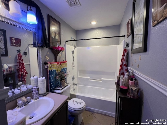 full bathroom featuring tile patterned flooring, shower / bath combination, toilet, and vanity