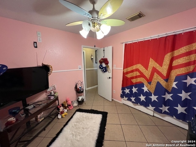 tiled bedroom with ceiling fan