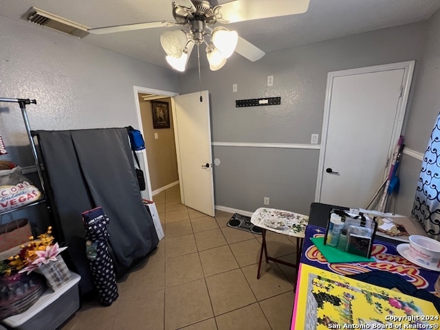 interior space featuring ceiling fan and light tile patterned flooring