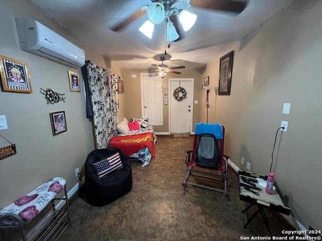 10131 Southern Sun, San Antonio, TX 78245 - playroom featuring an AC wall unit, ceiling fan, carpet flooring, and baseboards