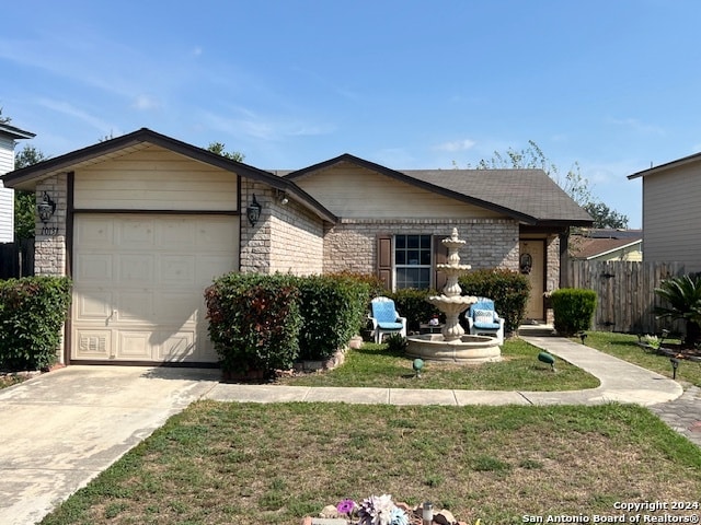 ranch-style home with a garage and a front lawn