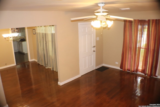 unfurnished room with vaulted ceiling, dark wood-type flooring, and ceiling fan