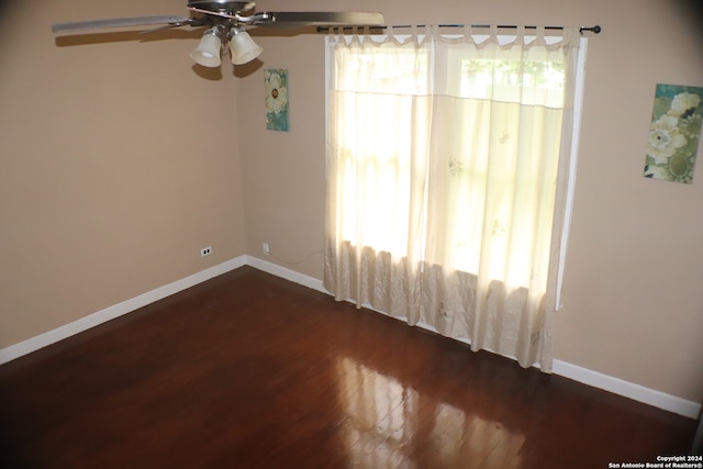 spare room featuring ceiling fan and dark hardwood / wood-style floors