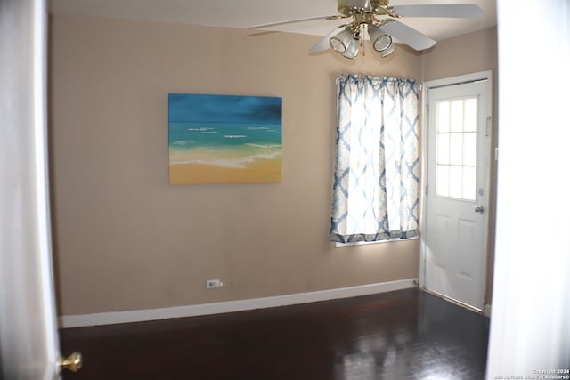 unfurnished room with ceiling fan and dark hardwood / wood-style floors