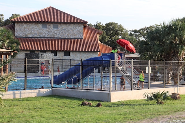 view of jungle gym featuring a fenced in pool and a yard