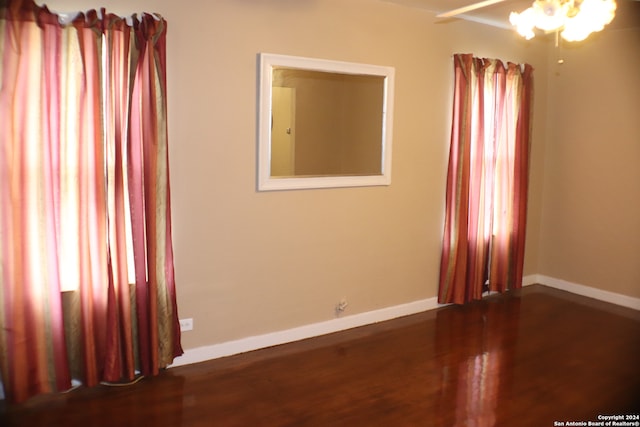 spare room with dark hardwood / wood-style flooring