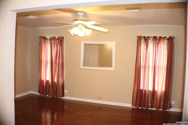 unfurnished room featuring ceiling fan and dark hardwood / wood-style floors