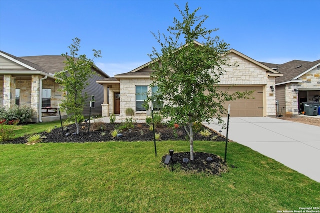 view of front of home with a front yard and a garage