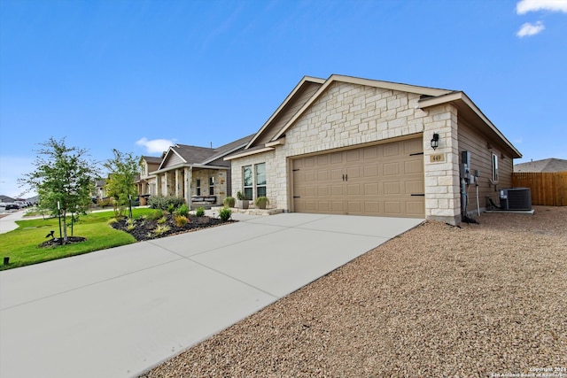 view of front of property with central AC and a garage