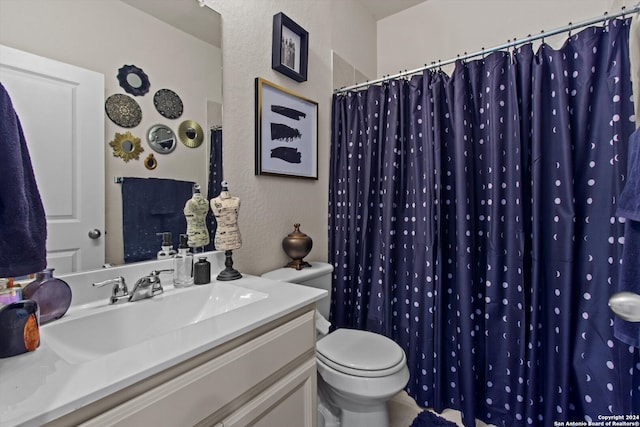 bathroom featuring toilet, curtained shower, and vanity