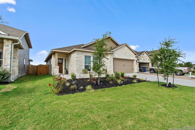 view of front of home with a front lawn and a garage