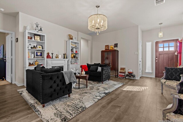 living room featuring a notable chandelier and hardwood / wood-style flooring