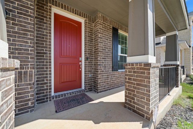 view of exterior entry with a porch