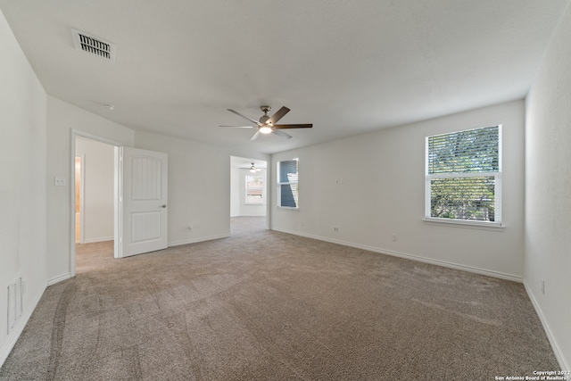 interior space with carpet flooring and ceiling fan