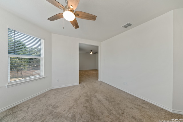 spare room with light carpet and ceiling fan