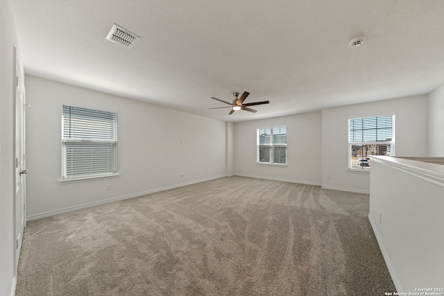 unfurnished room with light carpet and ceiling fan