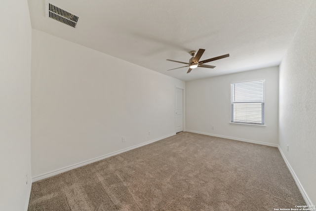 empty room featuring ceiling fan and carpet floors