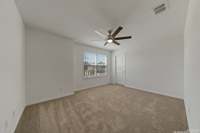 unfurnished room with ceiling fan and light colored carpet