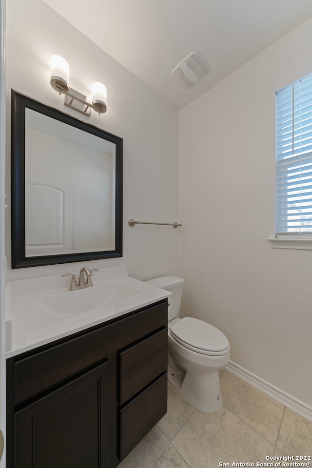 bathroom with tile patterned floors, toilet, and vanity