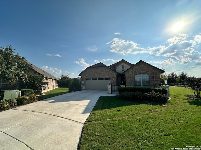 view of front of house with a garage and a front lawn