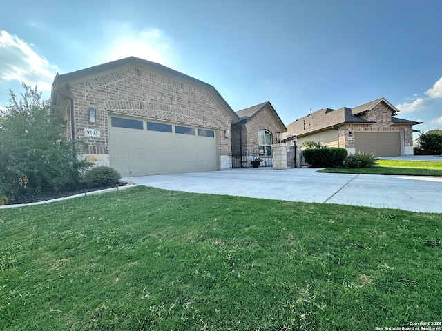 view of front of house with a front yard and a garage