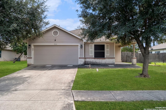 ranch-style house featuring a front yard and a garage