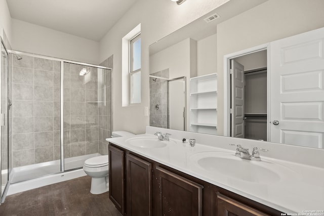 bathroom with walk in shower, vanity, toilet, and hardwood / wood-style flooring