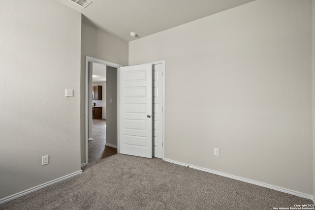 unfurnished bedroom featuring dark colored carpet