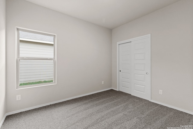 unfurnished bedroom with a closet and carpet flooring