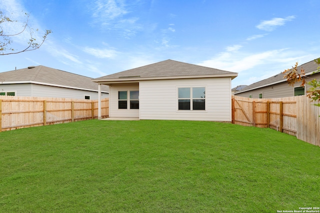 back of house featuring a yard