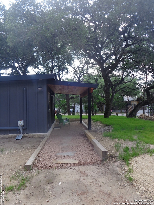 view of parking / parking lot featuring a carport