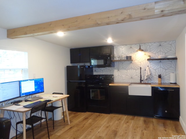 kitchen featuring backsplash, light wood-type flooring, black appliances, beam ceiling, and sink