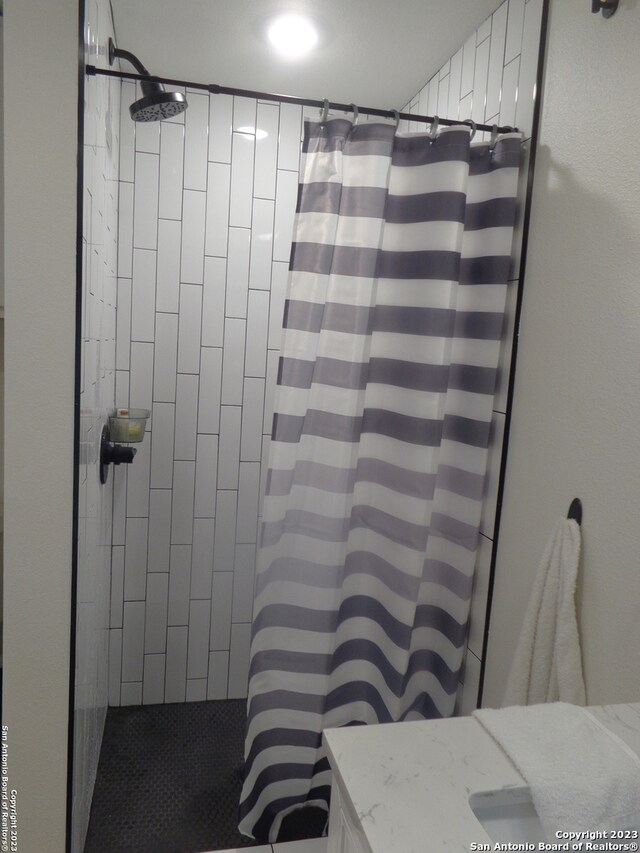 bathroom with walk in shower and vanity