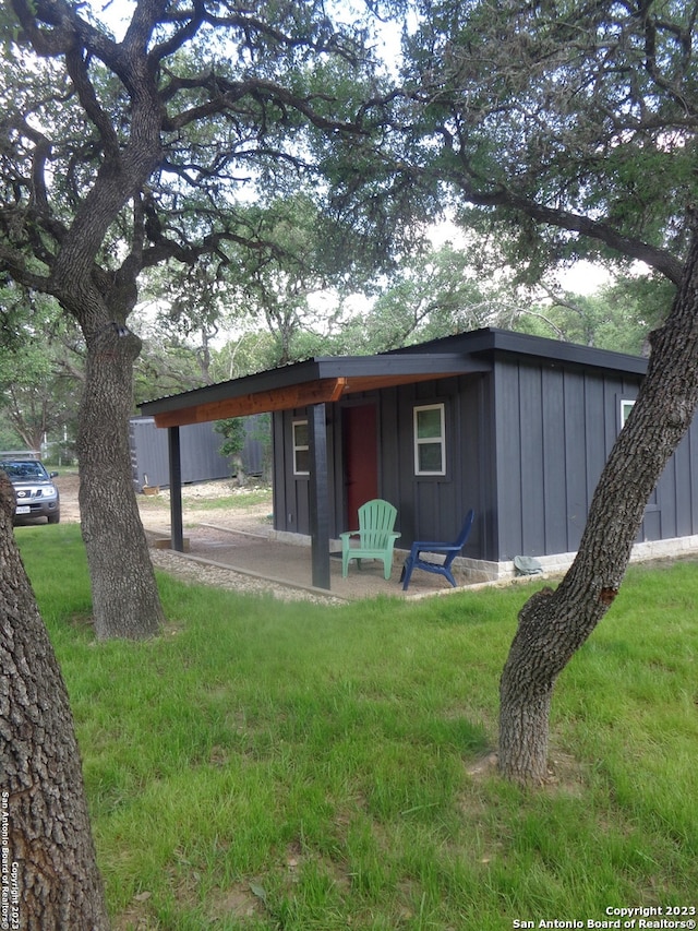 rear view of house featuring a yard