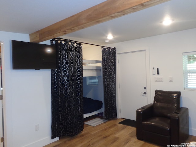 interior space with hardwood / wood-style floors and beamed ceiling