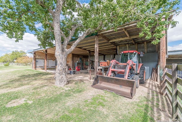 rear view of house with an outdoor structure and a yard