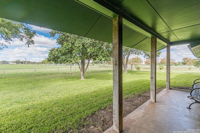 view of yard featuring a rural view and a patio