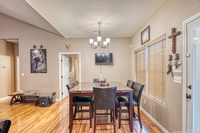 dining area featuring a notable chandelier and light hardwood / wood-style floors