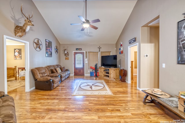 living room with light wood-type flooring, ceiling fan, and high vaulted ceiling