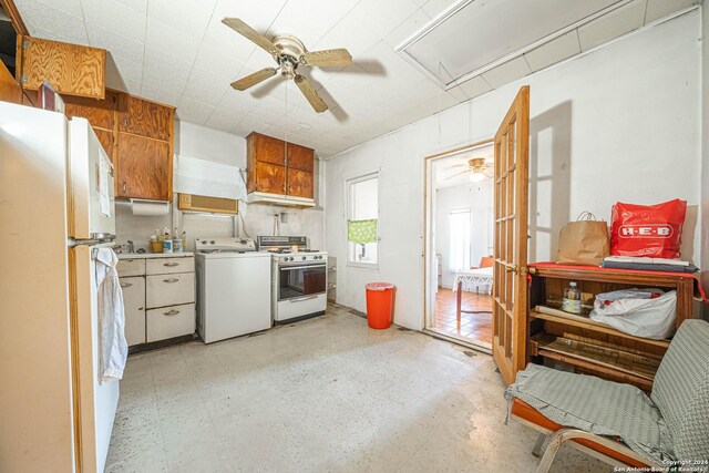 kitchen with white appliances, ceiling fan, and washer / dryer