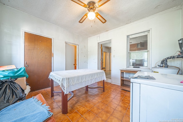 bedroom with a textured ceiling, light tile patterned floors, washer / clothes dryer, and ceiling fan