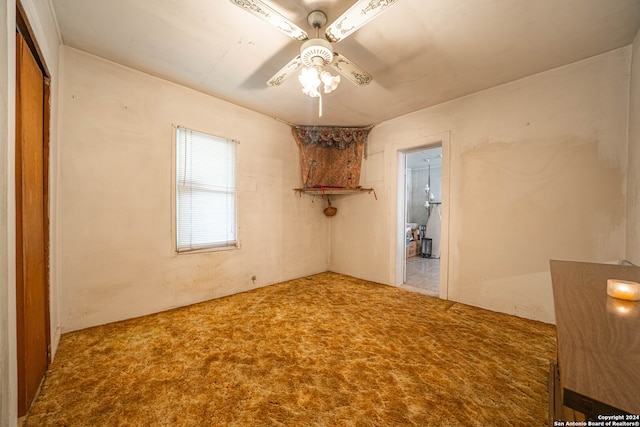 spare room featuring carpet and ceiling fan